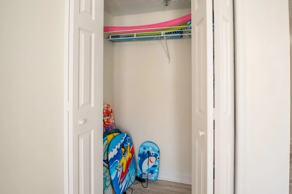 This vibrant image features colorful beach towels, surfboards, and pool noodles, ready for summer fun. The scene hints at the anticipation and excitement of beach and pool activities, perfect for families and grandchildren.